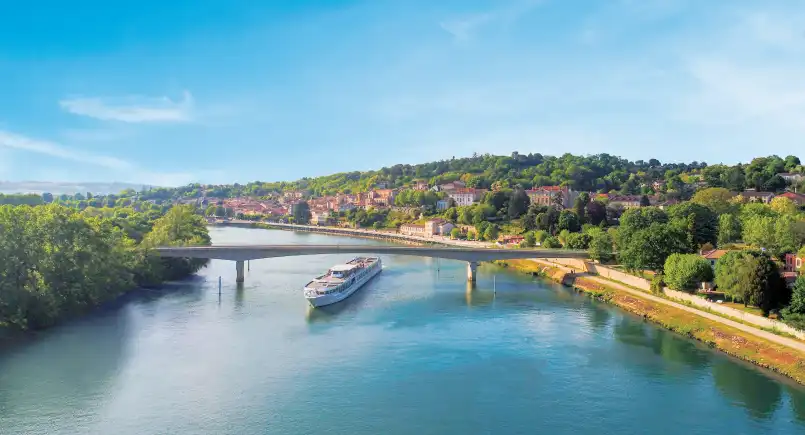 European river cruise ship docked beside a riverside town